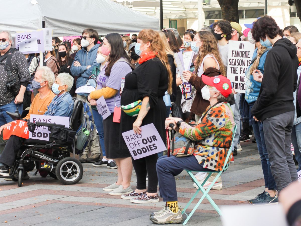 People listen to a speaker at the Rally for Abortion Rights at Westlake Center in Seattle