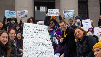 Advocates hold a giant banner of the "unfunded budget" on the Washington State Legislature's steps. Advocates hold a giant banner of the "unfunded budget" on the Washington State Legislature's steps.
