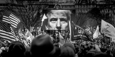 Trump's face on a screen at the Jan 6 Insurrection